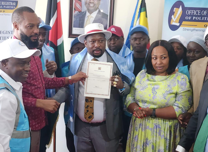 Former Nairobi Governor Mike Sonko displays a document while surrounded by supporters at the Office of the Registrar of Political Parties.