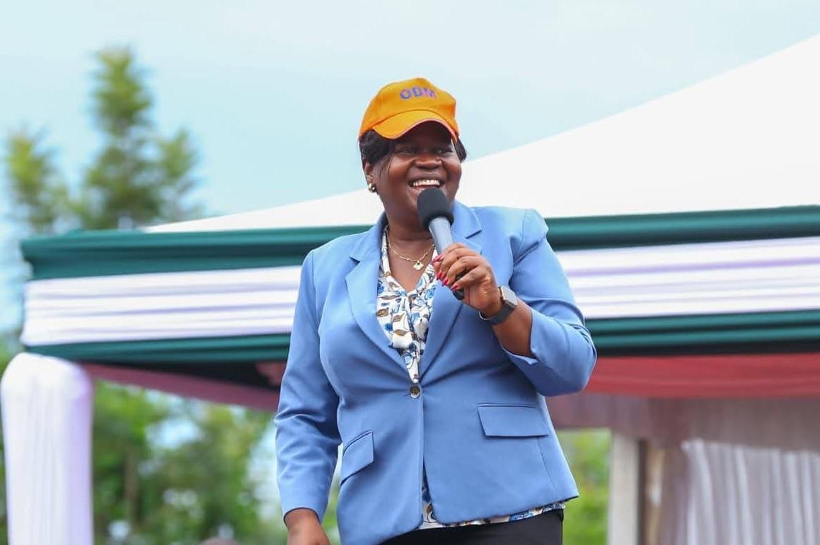 ODM National Chairperson Gladys Wanga addresses supporters while wearing an orange ODM cap during a political gathering.